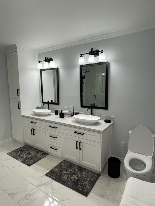 white large bathroom vanity with two vessel basin countertop and two mirrors with lighting