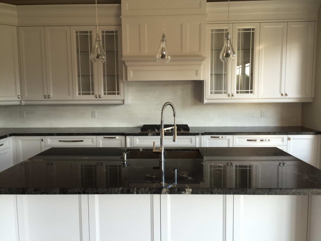 classic white theme kitchen renovation with marble countertop and island installed
