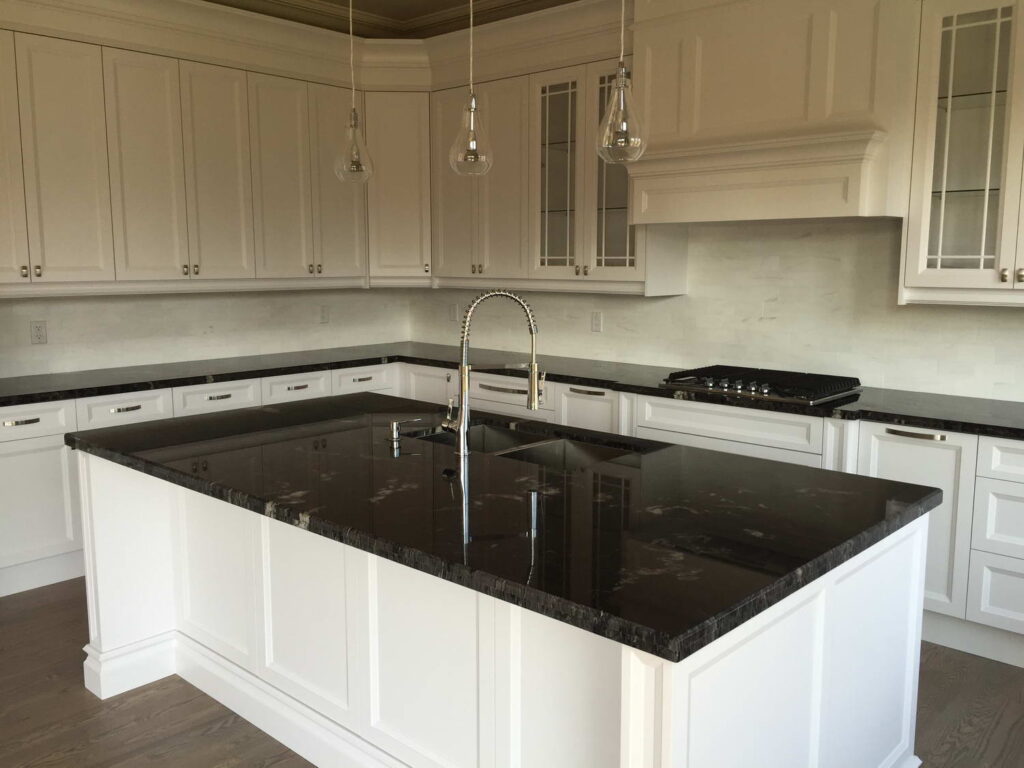 large center island with marble countertop and classic white cabinets