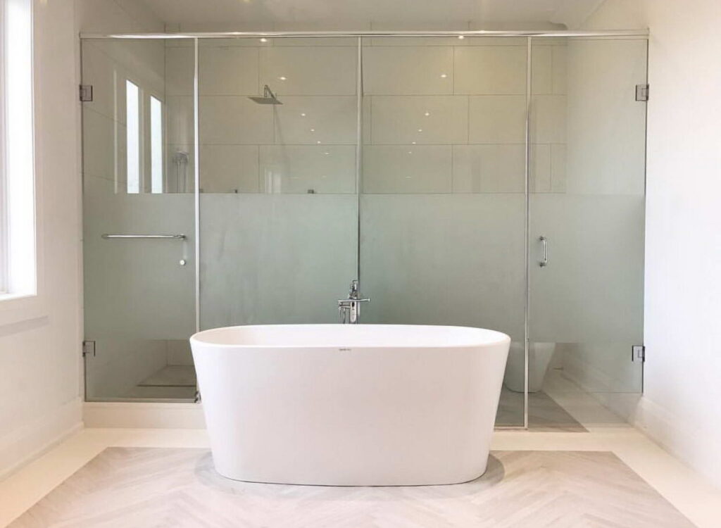 free standing bath tub with glass shower unit door and wall